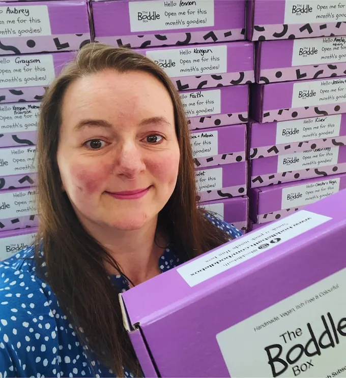 A Boddle Box held up in front of stacked boxes