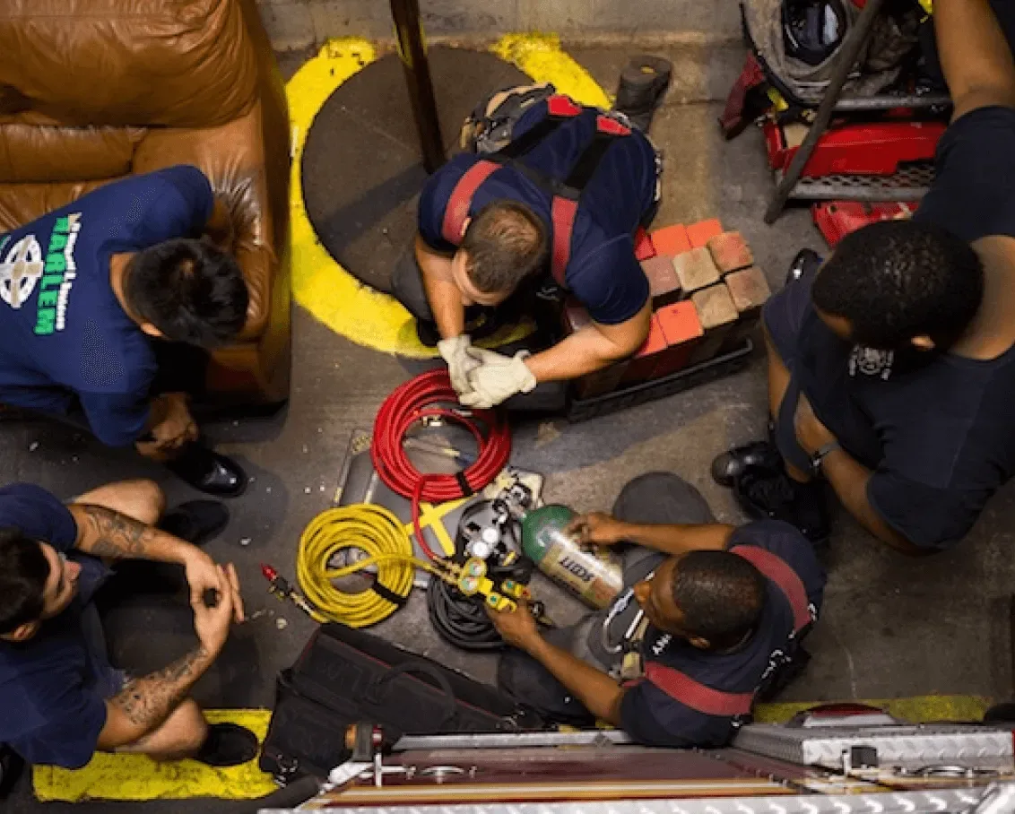 Firefighters looking down at gear from above