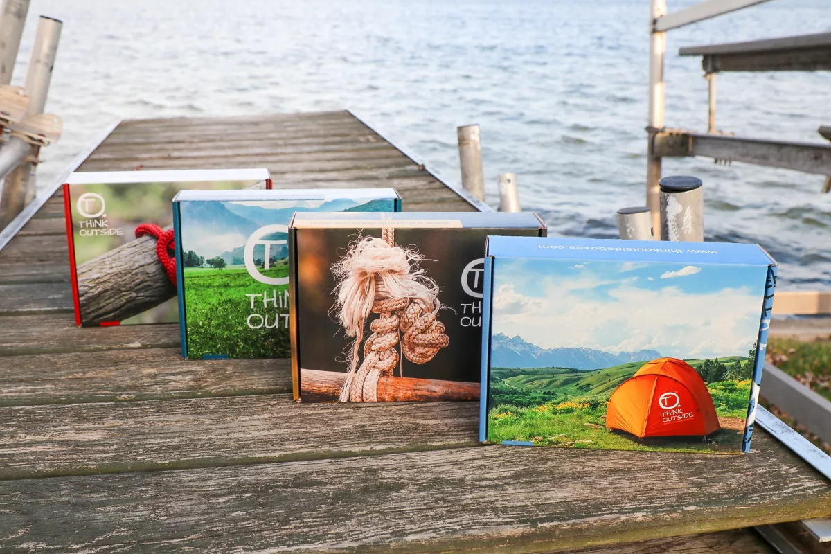 Think Outside Boxes postcards on a dock