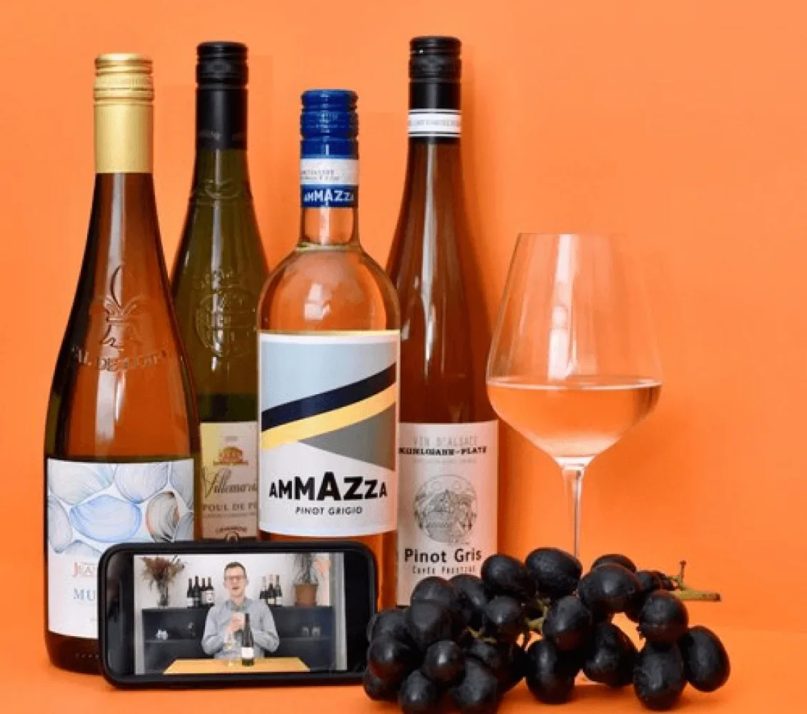 VinoMojo wine bottles and a glass of wine