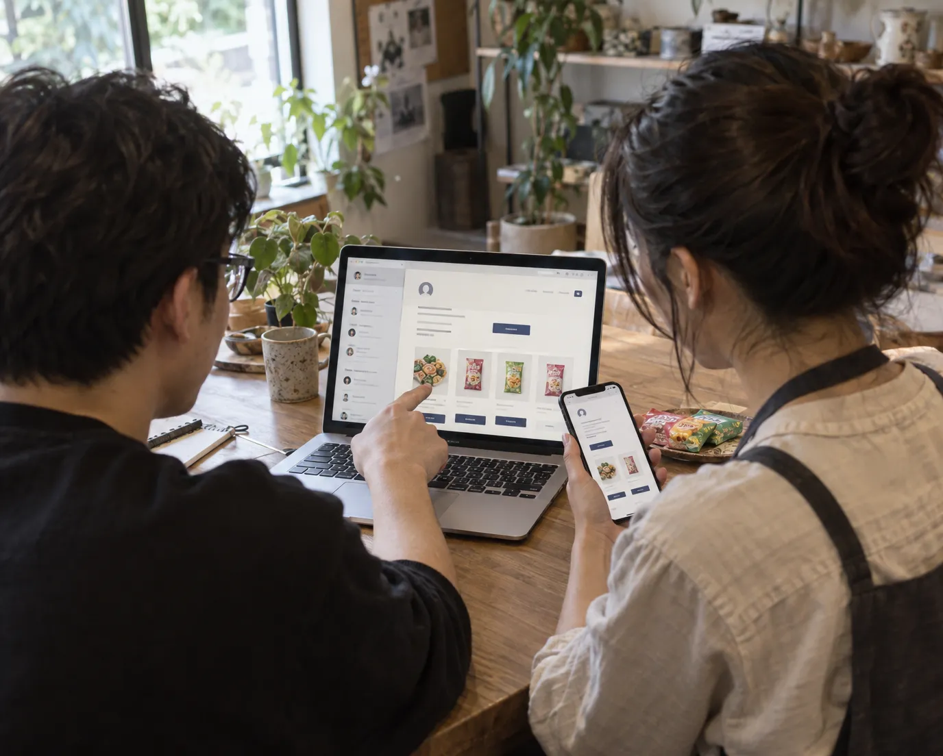 A designer and a client reviewing her new Subbly customer portal on a laptop and a phone.
